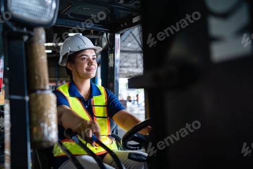 Preview: Female factory worker is driving a forklift in a large warehouse. A caring female factory worker dri