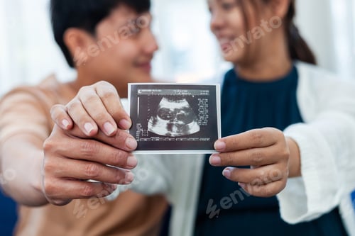 Preview: Close-up View Pregnant Woman Carefully Looking at Ultrasound Film With His Lover Look Happy Family P