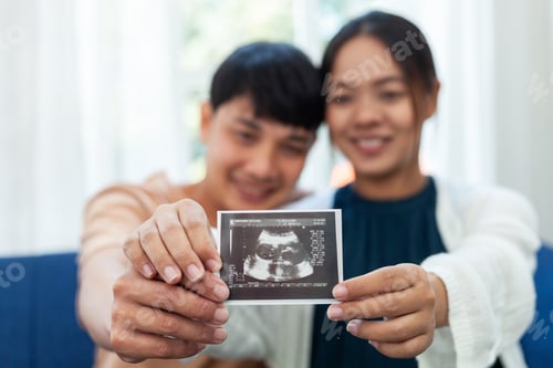 Preview: Man and Pregnant Woman Looking at Baby Ultrasound Pad With Her Lover Happy Pregnant Woman Looking at
