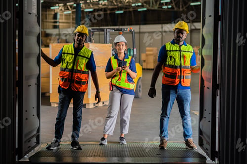 Preview: A group of African American workers checking the goods in the container. Factory workers are keeping