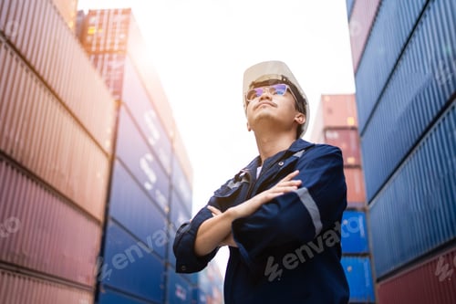 Preview: Portrait of Asian container construction engineer, worker standing supervising in container yard sit