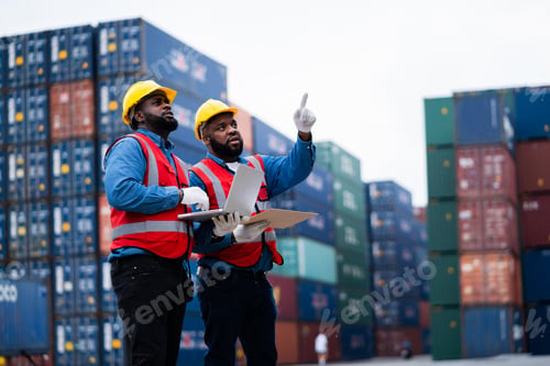 Preview: Two African engineers Supervising loading containers from cargo ships. logistics yard business Impor