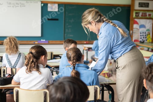 Preview: Elementary School Teacher Assisting Students During Classroom Lesson
