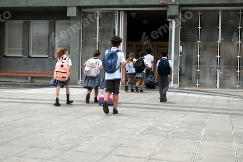 Preview: Group of primary school children walking into school