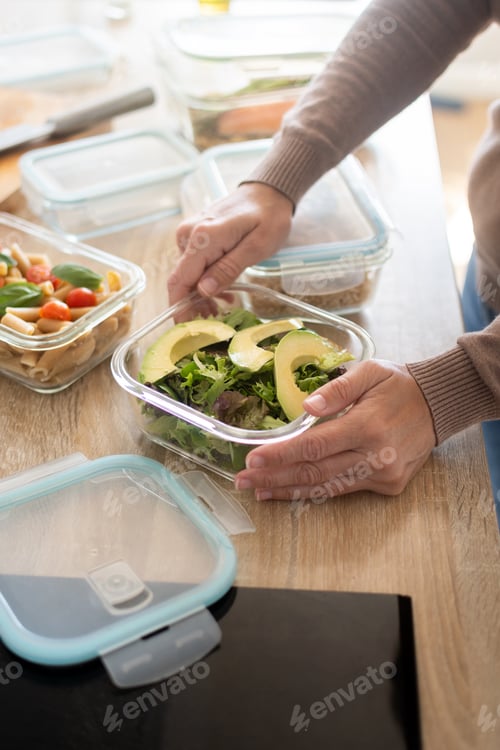 Preview: Woman Preparing Healthy Weekly Meal Prep Containers