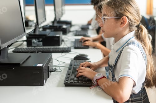 Preview: Elementary School Girl Using Desktop Computer During ICT Lesson