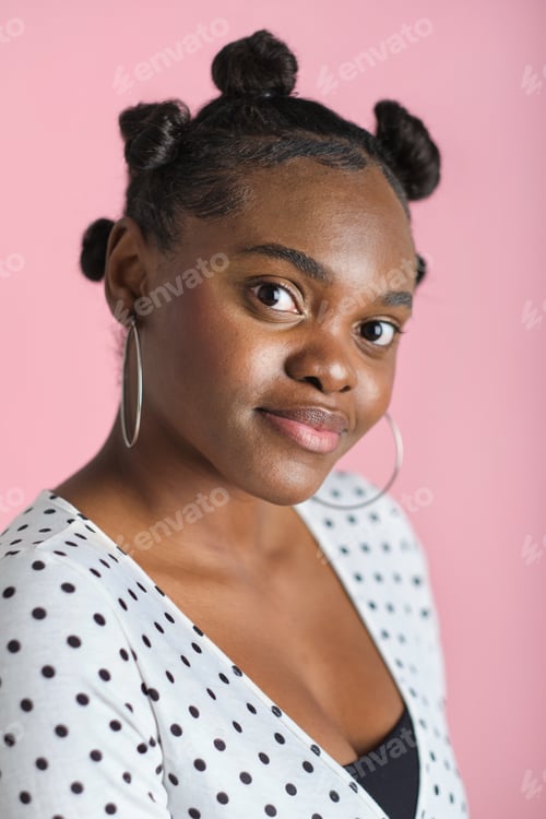 Preview: confident Young black woman posing in studio with bantu knots