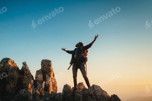 Preview: Silhouette stands atop jagged rock formations