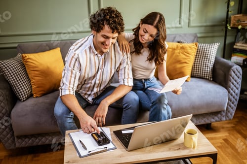 Preview: Young Couple Managing Finances Together on a Sofa at Home