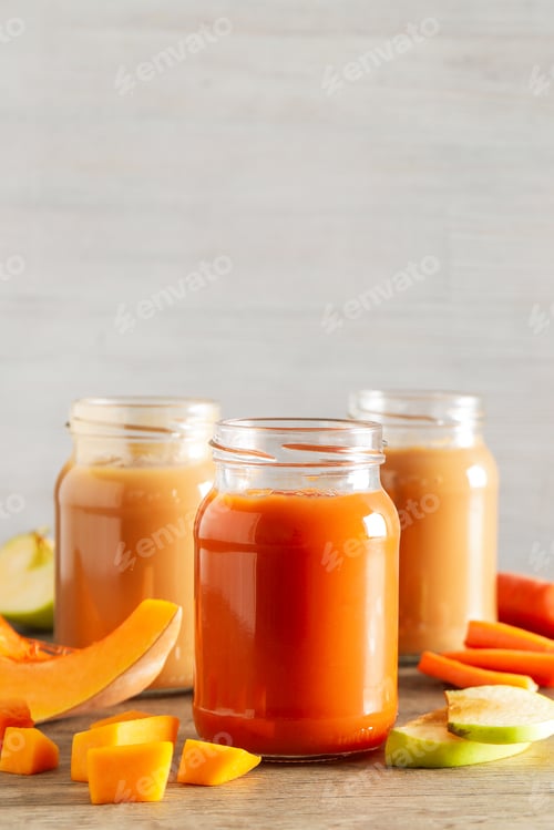 Preview: Three jars hold colorful juices next to pieces of fresh fruits