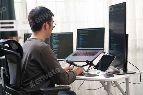 Preview: Focused Programmer Working with Multiple Monitors in an Office Environment for Coding Tasks