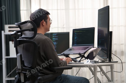Preview: Focused Developer Working on Multiple Monitors at a Workspace with Advanced Technology