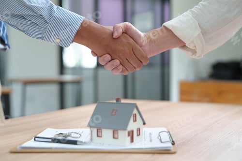 Preview: Business Handshake Over Home Purchase Agreement in Real Estate Transaction