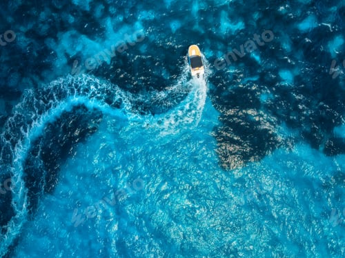 Preview: Aerial drone view of motorboat with curved wake in turquoise sea