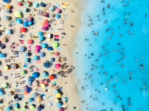 Preview: Aerial view of colorful umbrellas on sandy beach and blue sea