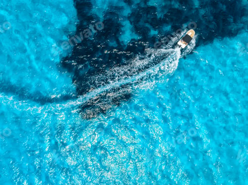 Preview: Aerial drone view of floating speed boat in blue sea on sunny day
