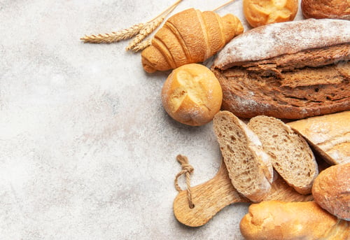 Preview: Assorted fresh bakery bread products on textured background