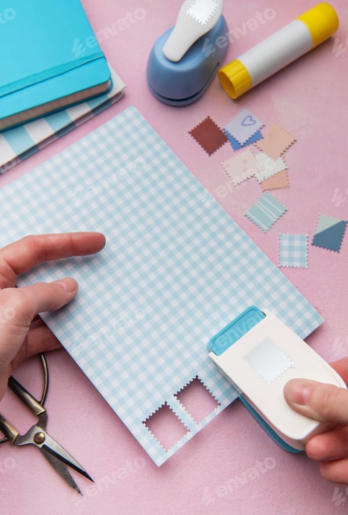 Preview: Hand using punch tool creating decorative craft stamps