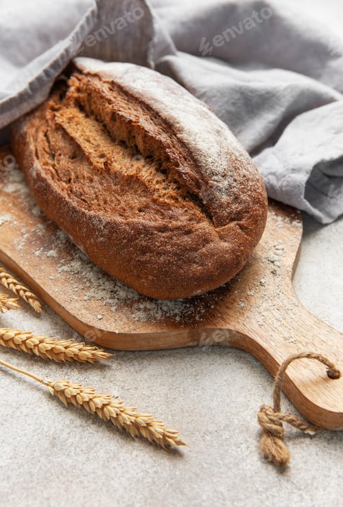 Preview: Fresh baked rye bread loaf on wooden board
