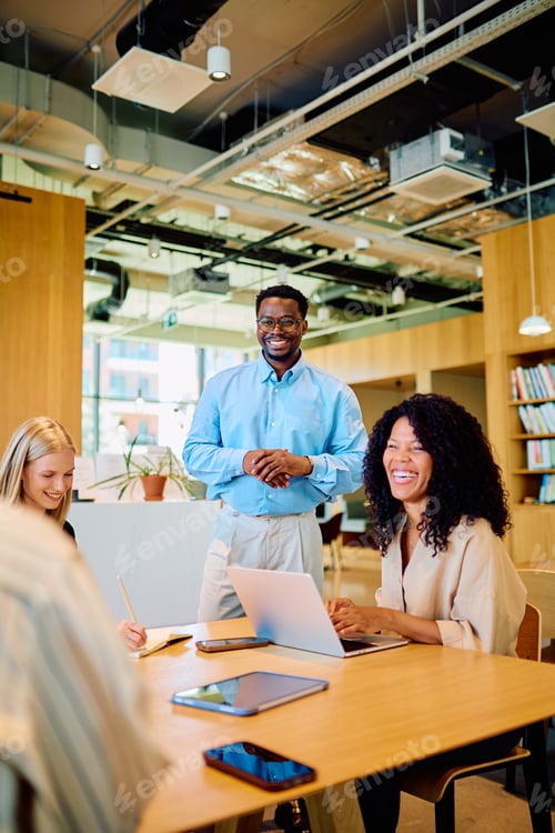 Preview: Diverse business team collaborating in a modern office meeting