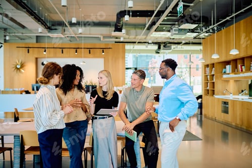 Preview: Multi-ethnic business team having an informal meeting in modern office