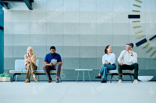 Preview: Diverse business professionals waiting in modern office lobby