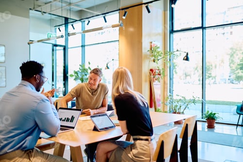 Preview: Business team discussing project data in modern office