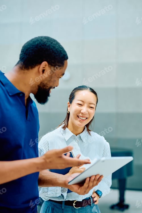 Preview: Business colleagues collaborating using tablet in office