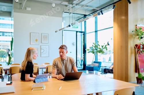 Preview: Business people collaborating discussing work in modern office