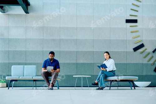 Preview: Business professionals waiting in a modern building lobby