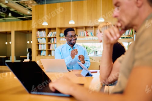 Preview: Diverse startup team collaborating in modern office setting