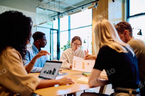 Preview: Diverse business team discussing project during meeting at office