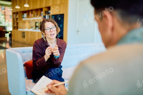 Preview: Woman actively discussing issues during a therapy session