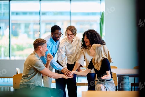 Preview: Business team collaborating successfully stacking hands cheerfully