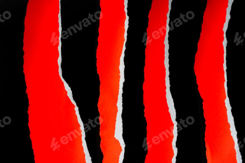 Preview: Close up of a red ripped or torn piece of paper with copy space, isolated black background.