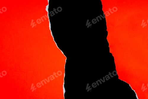 Preview: Red torn or ripped paper scraps with various shape lie scattered on a black surface.