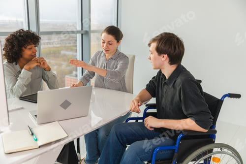 Preview: Teamwork brainstorm. Diverse multiracial colleagues man in chair for people with disability working