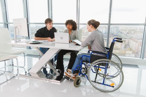 Preview: Teamwork brainstorm. Diverse multiracial colleagues woman in chair for people with disability workin