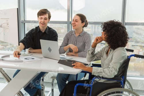 Preview: Teamwork brainstorm. Diverse multiracial colleagues woman in chair for people with disability workin