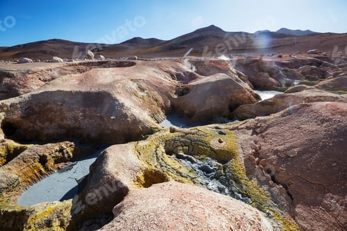 Boiling Geothermal Mud Pots in a Vast Volcanic Mountain Landscape