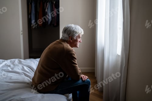 Preview: Desperate lonely elderly man sitting with blank stare showing signs of despair and mental decline
