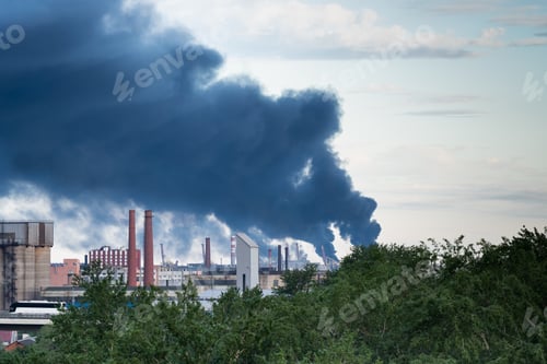 Preview: Plumes of multiple tall smokestacks rising in sky after fire accident at asphalt factory production