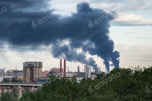 Preview: Plumes of multiple tall smokestacks rising in sky after fire accident at asphalt factory production
