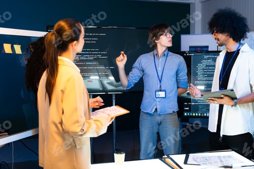 Preview: Diverse tech team brainstorm software code on screen