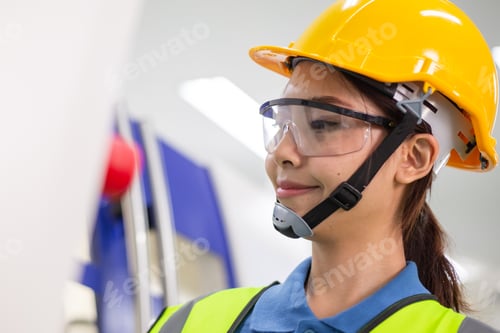 Preview: Engineer woman operating high technology factory machine