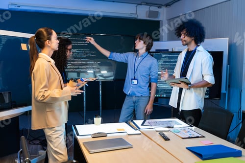 Preview: Software developer explaining and reviewing code on screen at the meeting