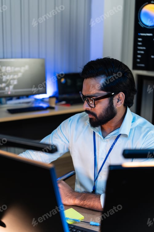 Preview: Indian software engineer works on multiple computer