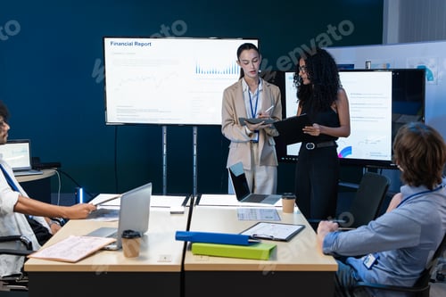 Preview: Business Team Analyzing Financial Growth Data on Monitors During Meeting