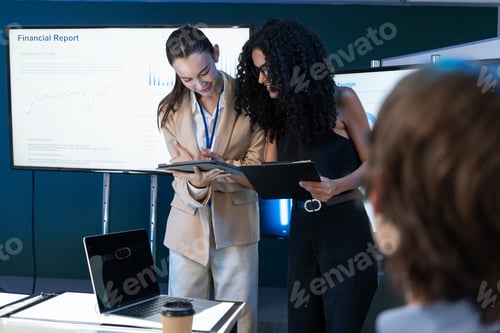 Preview: Business team discussing and watching on tablet during the meeting