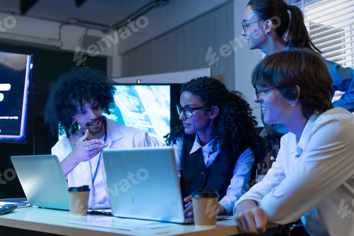 Preview: Developer team brainstorming and reviewing code on laptop at the office